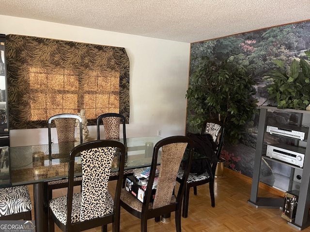 dining room featuring parquet floors and a textured ceiling