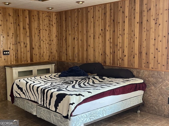 tiled bedroom featuring wood walls