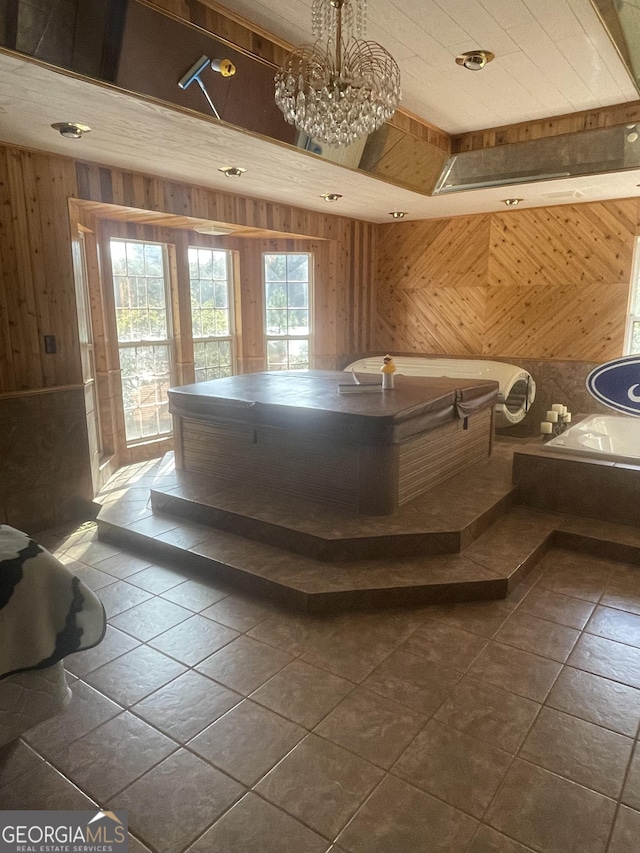 bathroom with tile patterned floors, wood walls, and an inviting chandelier