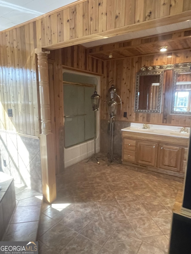 bathroom with vanity and wood walls