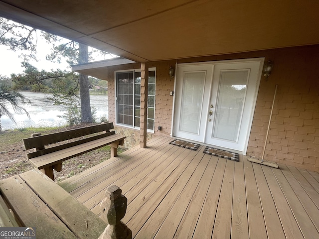 wooden deck with a water view