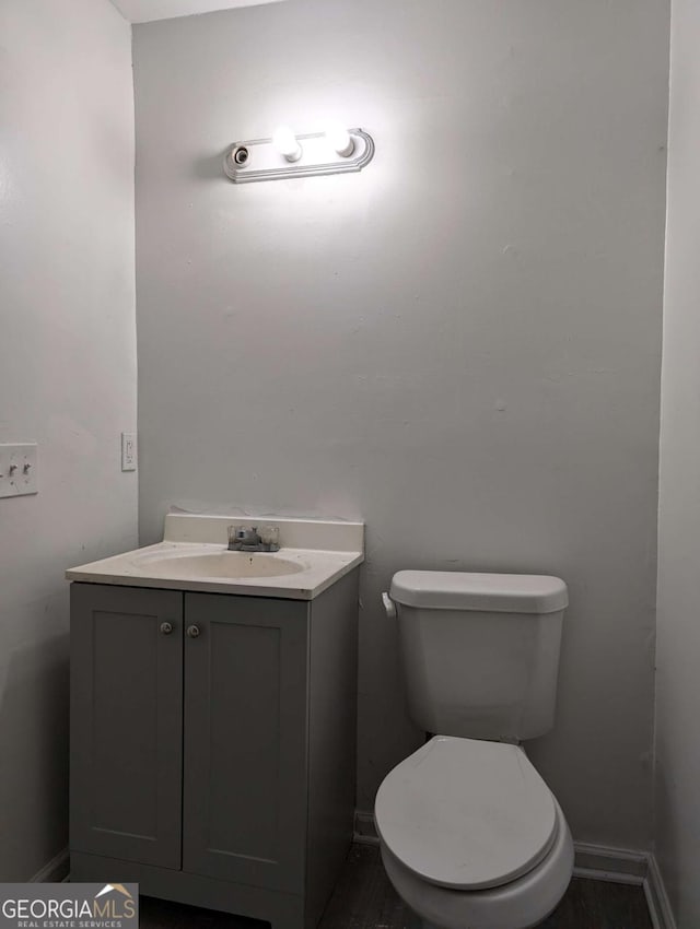 bathroom featuring vanity and toilet