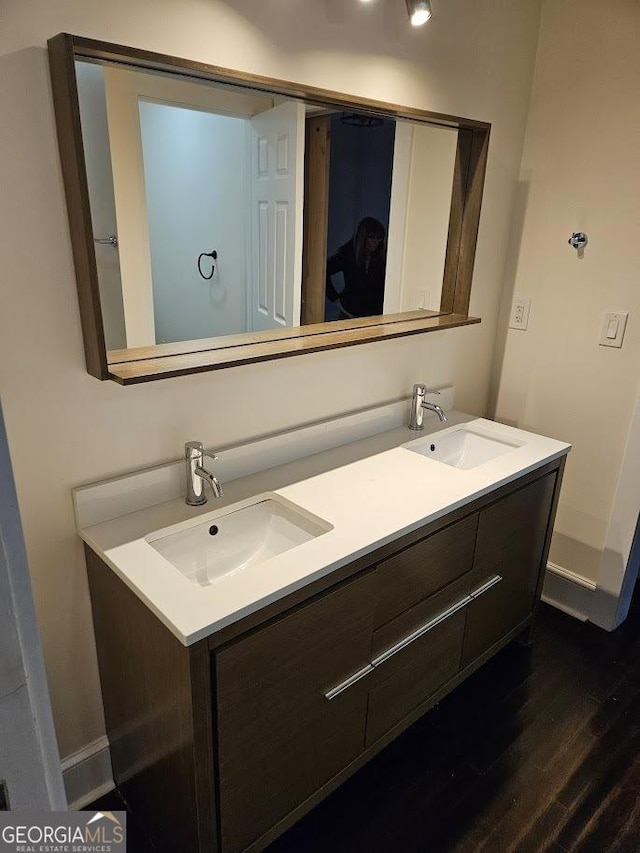 bathroom with vanity and hardwood / wood-style flooring