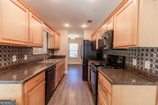 kitchen with light brown cabinets, sink, light hardwood / wood-style flooring, and black appliances