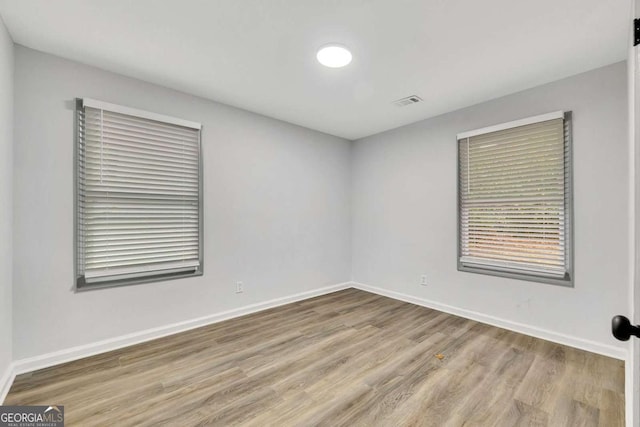 unfurnished room with light hardwood / wood-style flooring