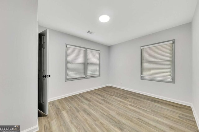 unfurnished room with light hardwood / wood-style flooring