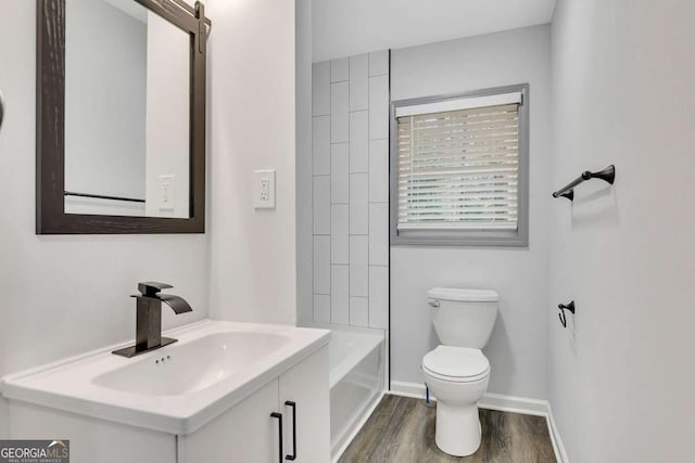 full bathroom featuring shower / bathing tub combination, wood-type flooring, toilet, and sink