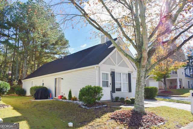 view of property exterior featuring a lawn and a garage