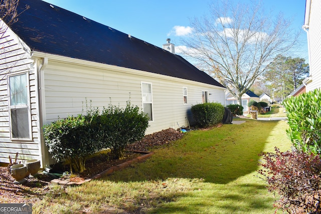 view of property exterior with a lawn