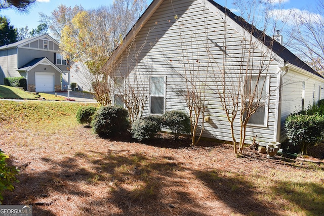 view of side of home with a garage