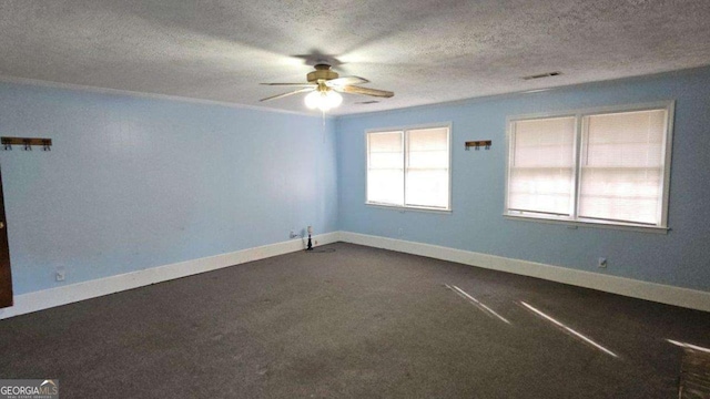 carpeted empty room with ceiling fan and a textured ceiling