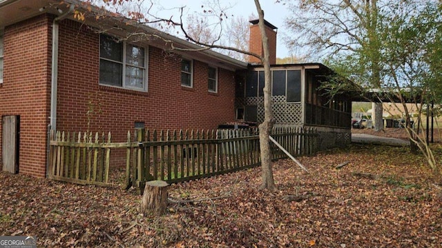 view of home's exterior with a sunroom