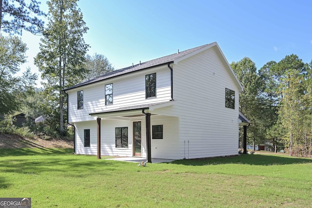 back of house featuring a yard and a patio