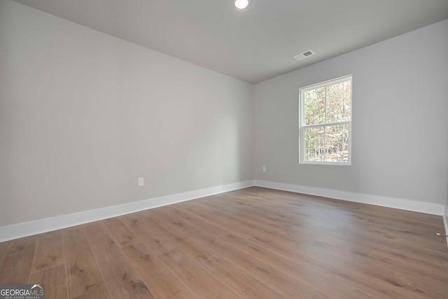 unfurnished room with light wood-type flooring