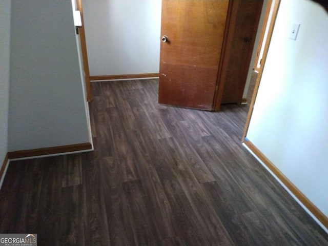 hall with dark wood-type flooring