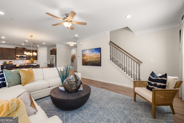 living room with ceiling fan, dark hardwood / wood-style flooring, and ornamental molding