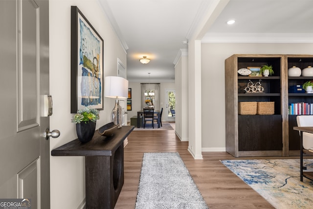 entrance foyer with wood-type flooring and ornamental molding