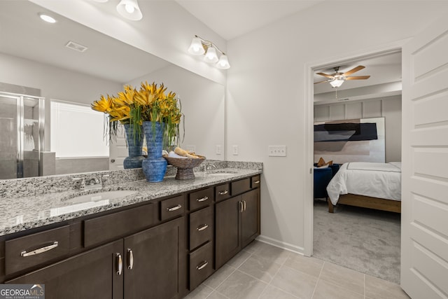 bathroom with tile patterned flooring, vanity, ceiling fan, and an enclosed shower