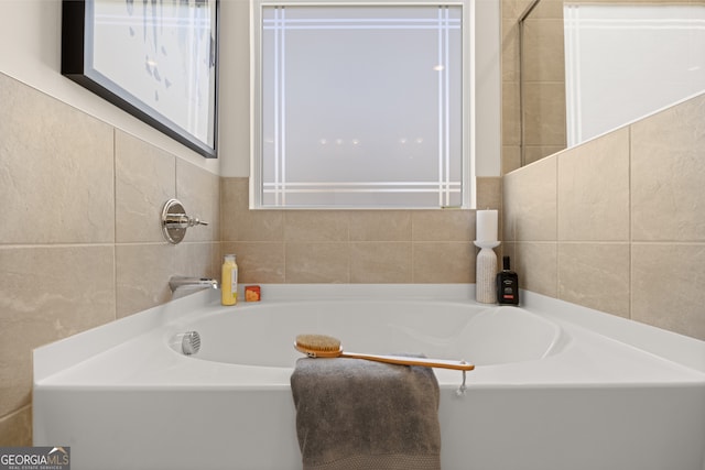 bathroom featuring tile walls and a bathing tub