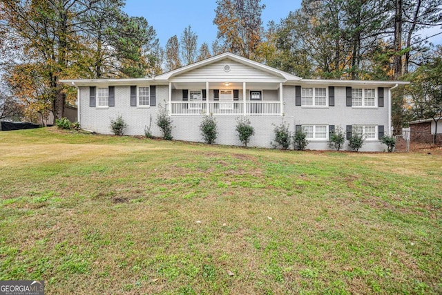 single story home with covered porch and a front yard