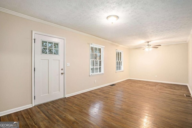 foyer entrance featuring a textured ceiling, ceiling fan, dark hardwood / wood-style flooring, and crown molding