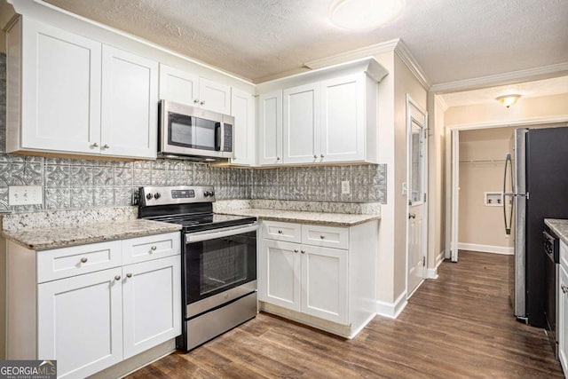 kitchen featuring decorative backsplash, dark wood-type flooring, white cabinets, and stainless steel appliances