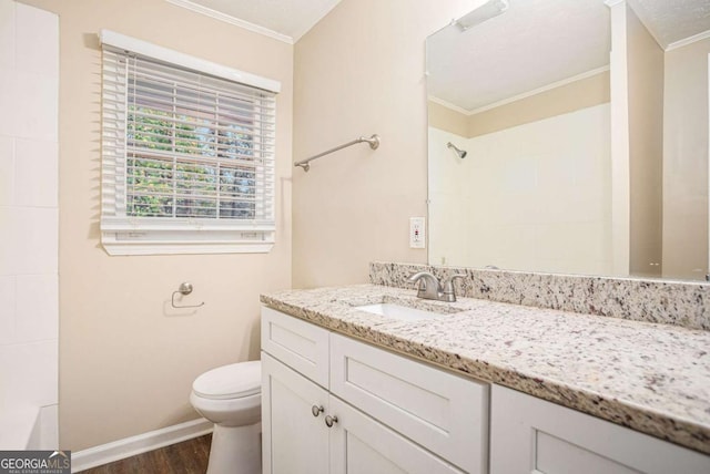 bathroom with crown molding, wood-type flooring, a textured ceiling, toilet, and vanity