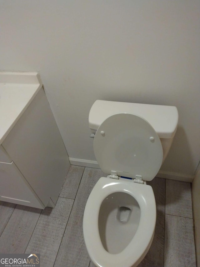 bathroom with hardwood / wood-style floors and toilet