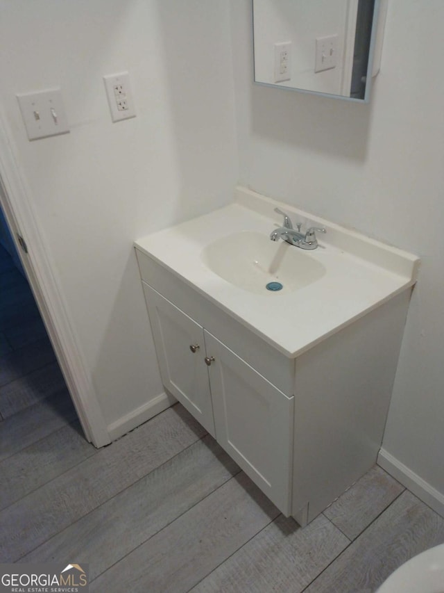 bathroom with hardwood / wood-style floors and vanity