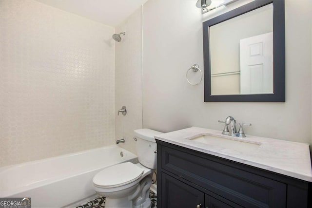 full bathroom with tiled shower / bath, vanity, and toilet