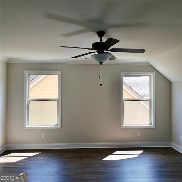 additional living space with lofted ceiling, ceiling fan, and dark hardwood / wood-style floors