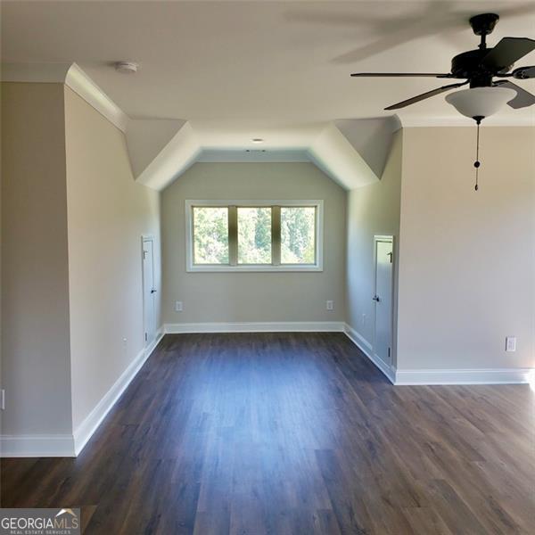 bonus room with dark hardwood / wood-style floors and ceiling fan