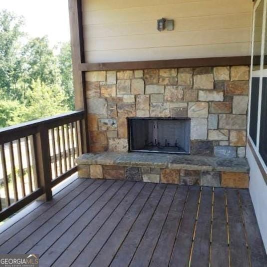 wooden deck with a fireplace