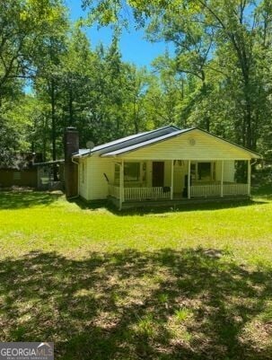 exterior space with a front lawn and a porch