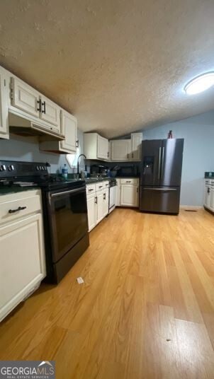 kitchen featuring light wood-type flooring, black electric range, sink, refrigerator with ice dispenser, and white cabinets