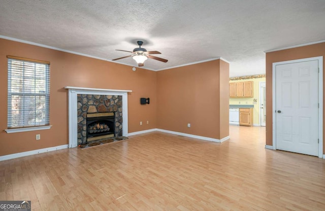 unfurnished living room featuring a textured ceiling, a fireplace, light hardwood / wood-style floors, and crown molding