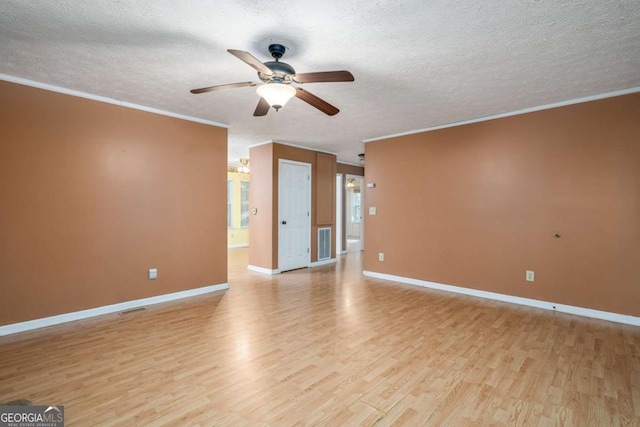 empty room with a textured ceiling, light wood-type flooring, ceiling fan, and crown molding