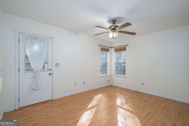 entryway with ceiling fan and light hardwood / wood-style floors