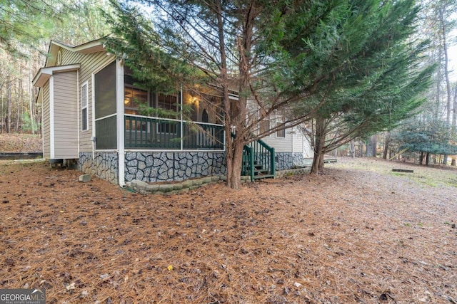 view of side of home featuring a sunroom