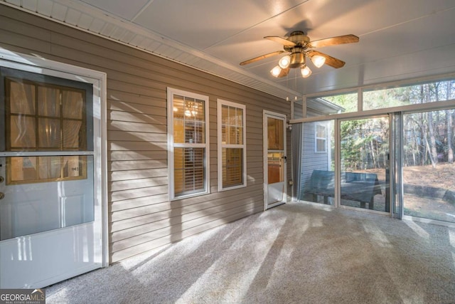 unfurnished sunroom with ceiling fan