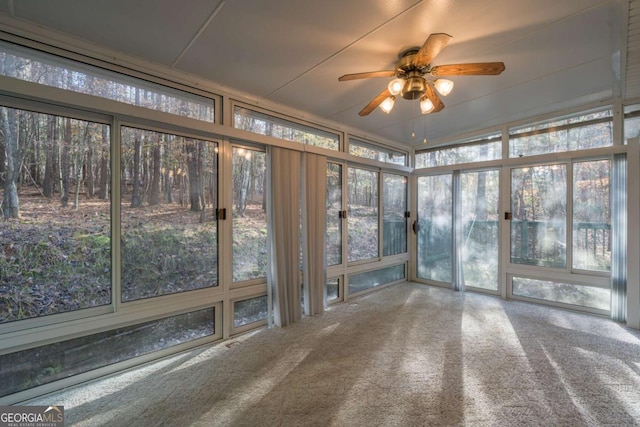 unfurnished sunroom featuring ceiling fan