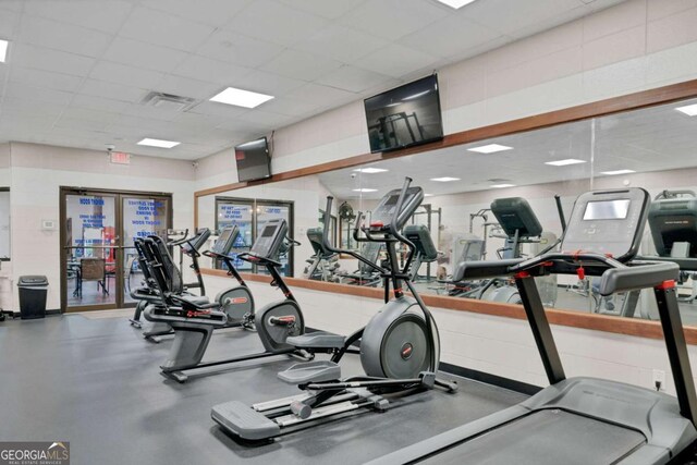 workout area featuring a drop ceiling