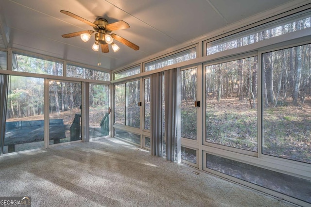 unfurnished sunroom featuring ceiling fan