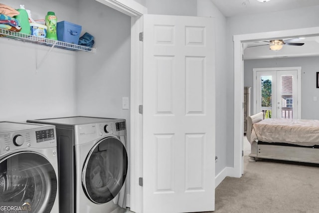 clothes washing area with light carpet, independent washer and dryer, french doors, and ceiling fan