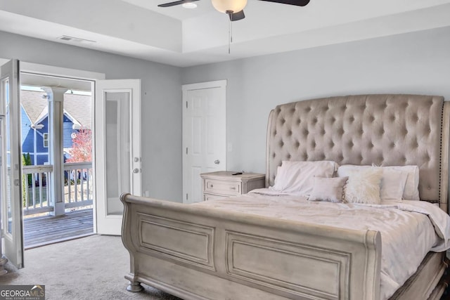 bedroom featuring access to outside, light colored carpet, multiple windows, and ceiling fan