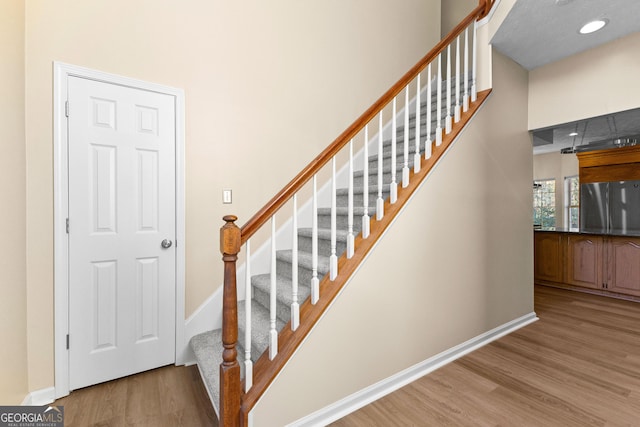 staircase featuring wood-type flooring