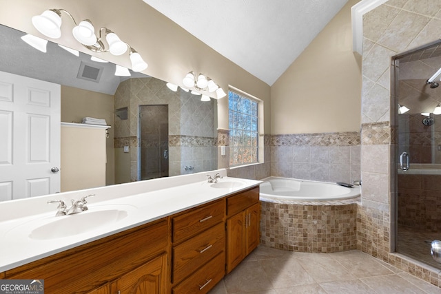 bathroom with tile patterned flooring, vanity, tile walls, vaulted ceiling, and separate shower and tub