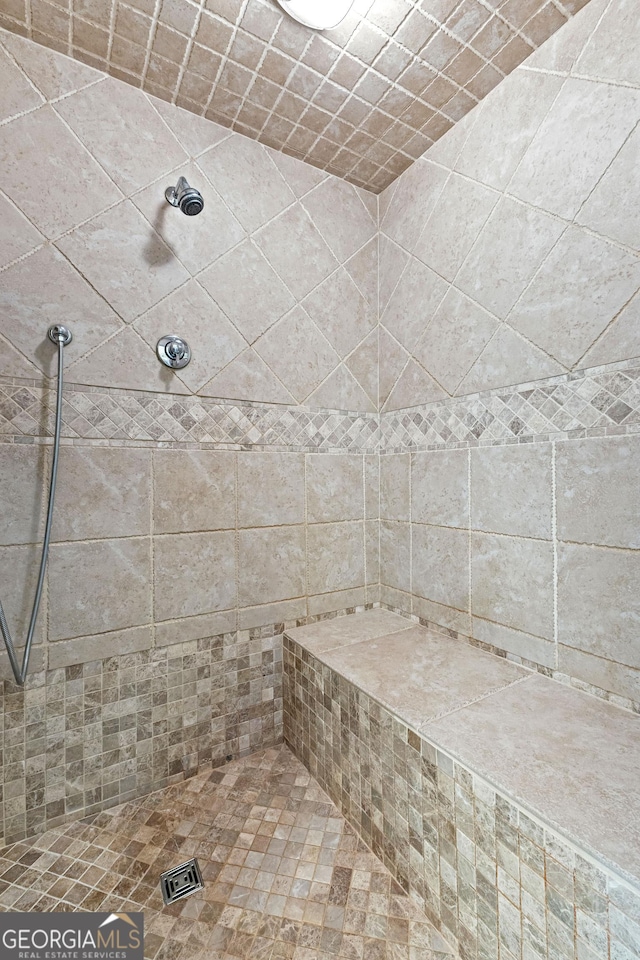 bathroom with tiled shower