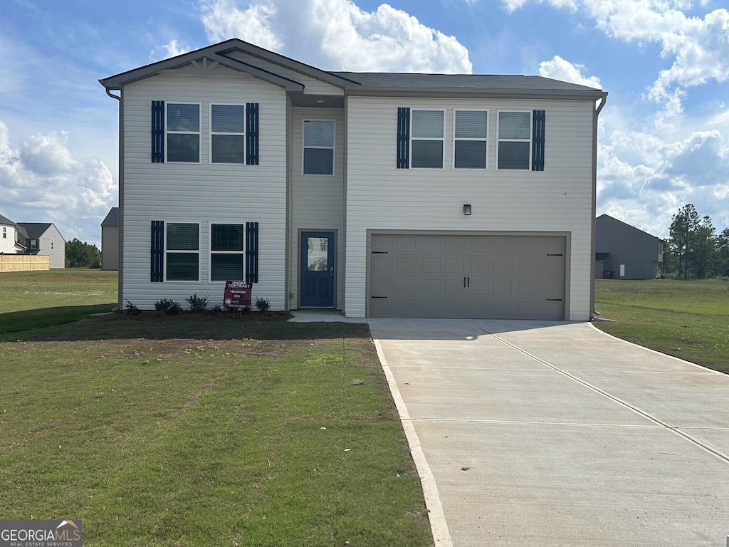 view of front of house featuring a front yard and a garage