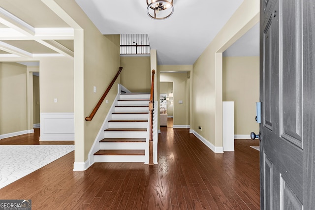 entrance foyer with dark wood-type flooring and coffered ceiling